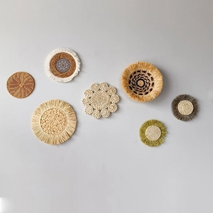 7-piece bohemian woven grass wall decor set with natural fiber round plates on grey wall