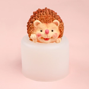3D hedgehog silicone mold with a finished brown resin hedgehog on a pink background