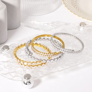 Set of four gold and silver plated stainless steel bangles with pave cubic zirconia crystals