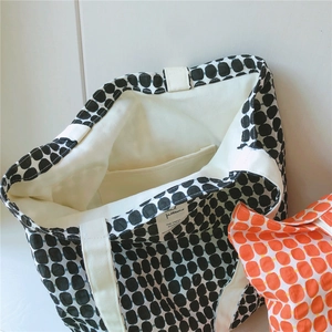 Close-up of geometric cotton tote bag with white lining and inner pocket detail