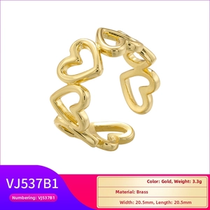 Detail view of gold brass ring with multi-heart linked design and technical measurements