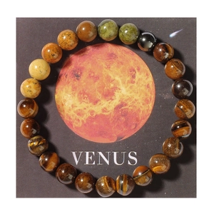 Macro detail of natural tiger eye stone beads on Venus cosmic themed solar system bracelet