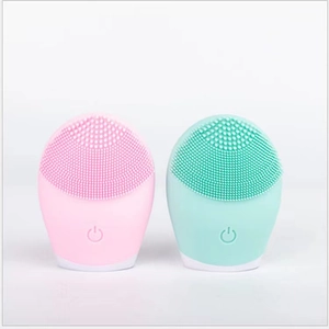 Pink and mint green facial cleansing brushes with soft silicone bristles for pore cleaning