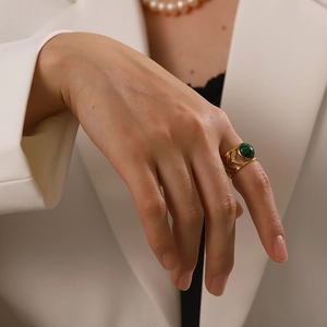 Detail of 18K gold stainless steel ring with green malachite and leaf pattern