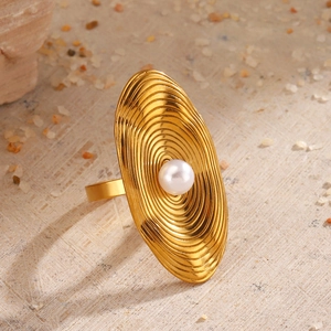 Golden oval stainless steel ring featuring concentric ripple textures and a center pearl