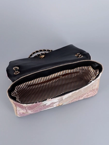Detailed interior of a pink sequin floral bag with brown lining and gold chain