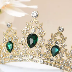 Macro shot of gold tiara featuring sparkling rhinestones and green teardrop gemstones