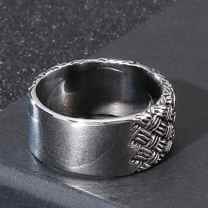 Détail d'une bague en acier avec texture tressée et surface intérieure lisse et polie