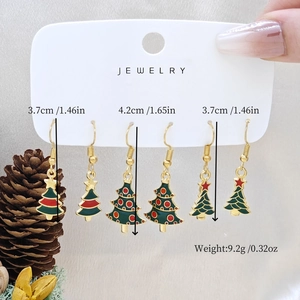 Three pairs of Christmas tree earrings set with measurements on card and pinecone detail