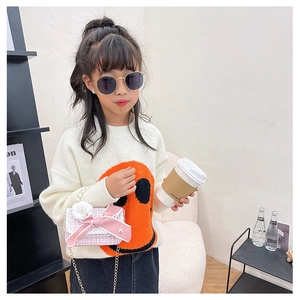 Pink and white woven crossbody bag with pearl handle and bow shown on child model