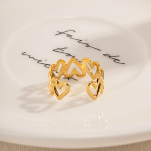Detailed macro view of gold hollow heart ring on a vintage porcelain plate accessory