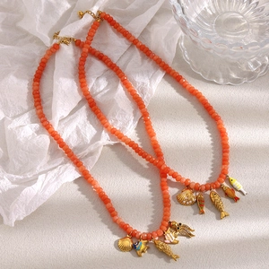 Handmade orange beaded necklace with 18K gold plated ocean pendants shell and crab