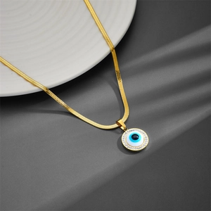 Gold snake chain necklace with a blue evil eye pendant and white zircon accents