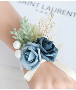 Detailed shot of blue artificial rose wrist corsage with succulent and pearls