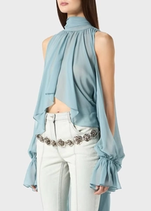 Detail of light blue chiffon halter top featuring draped pleats and detached long sleeves
