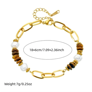 Gold stainless steel bracelet with tiger eye stones and pearls on white background