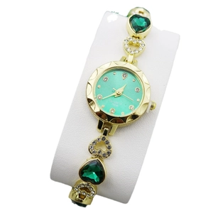 Elegant women's gold quartz watch with green heart gems and sparkling diamond bracelet
