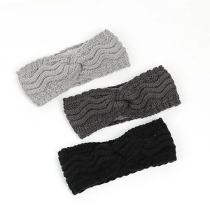 Detailed knit texture of three winter wide headbands with decorative twist knots