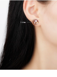 Close-up of 7.5-8mm natural pink freshwater pearl stud earring worn on earlobe