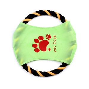 Detail of durable woven cotton dog chew toy with green fabric center and red paw print