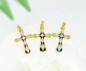 Macro detail of 18K gold plated cross pendants with colorful enamel and zircon stones