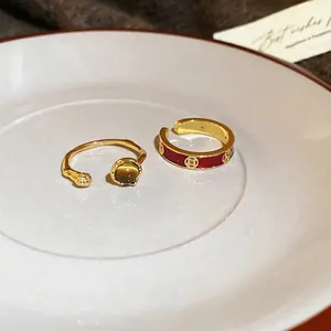 18k gold plated open ring set with tiger eye stone and red enamel coin pattern detail