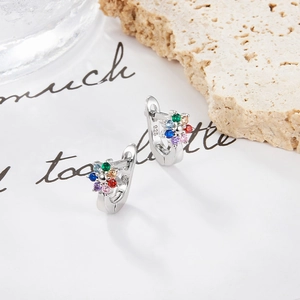 Macro view of S925 sterling silver hoop earrings featuring colorful cubic zirconia flowers