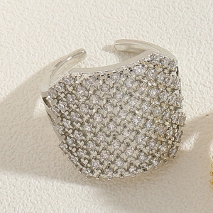 Close-up of wide silver ring with full pavé cubic zirconia and adjustable open band