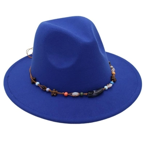 Detail of royal blue wool fedora featuring colorful beadwork and bohemian wooden floral accents
