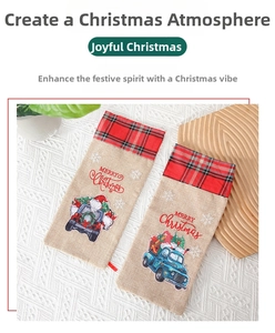 Close-up of linen Christmas wine gift bags with festive truck prints and red plaid trim
