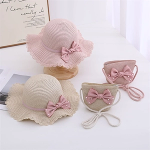 Matching kids straw hat and crossbody bag set with elegant ribbon bow and pearls