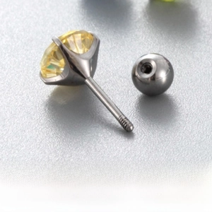 Detailed macro view of 6mm yellow firework zircon earring with titanium screw ball back