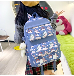 Blue unicorn nylon backpack for girls with cute bear charm shown in a lifestyle scene