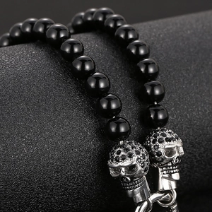 Men's gothic skull necklace featuring black onyx beads and polished silver pendants