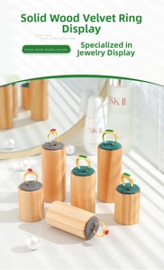 Detailed view of wooden ring stands with velvet tops and natural light shadow