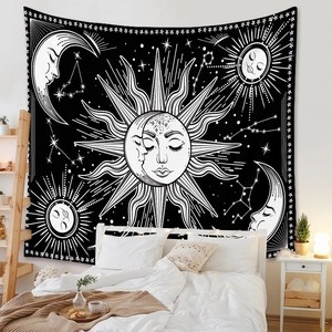 Close-up of bohemian sun and moon tapestry hanging above a bed for room decoration