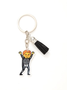 Detail of acrylic Halloween keychain with skeleton boy charm and black tassel fringe