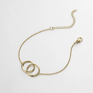 Detail view of interlocking double rings and lobster clasp on 18K gold stainless steel bracelet