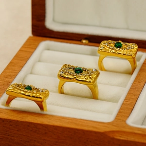 Detail view of retro gold stainless steel rings with green turquoise and zircon inlay