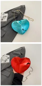 Close-up of heart-shaped acrylic evening bags in blue and red with metallic chain