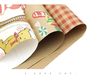 Close-up of vintage Christmas wrapping paper with bear patterns and brown plaid texture