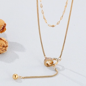 Double-layered gold necklace with crystal-encrusted interlocking rings and beads