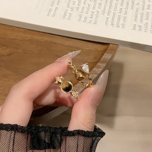 Detail view of 18k gold plated tiger eye ring with adjustable band on wooden background