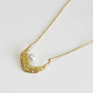 925 silver crescent moon necklace with white pearl in gold finish on white background