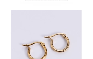 Macro shot of minimalist gold plated stainless steel hoop earrings with latch back closure