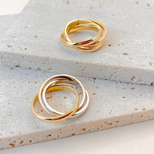 Polished stainless steel interlocking triple band rings in gold and tricolor finishes
