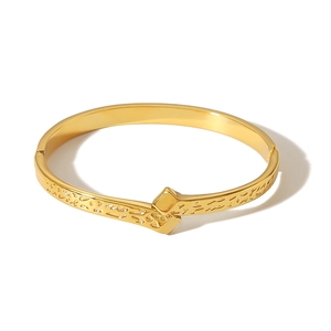 Modern gold geometric bracelet with rock texture finish and secure square lock closure