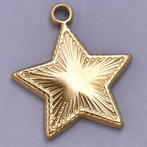 Detail of gold star pendant with radial texture and connecting ring for necklaces