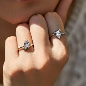 Elegant S925 sterling silver ring with shimmering water drop zircon on a female hand