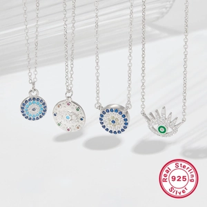 Close-up of four 925 sterling silver evil eye pendants with vibrant colorful gemstones